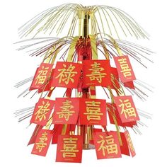 a red and gold christmas tree with chinese characters on it's branches in front of a white background