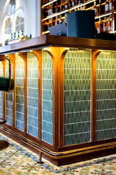 an old fashioned bar with many bottles behind it