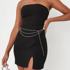 Sleeveless Bandeau Mini Dress Featuring A Silver Chain Detail. Fitted Chain Detail Dress For Night Out, Fitted Chain Dresses For Night Out, Summer Dresses With Chain Strap, Chic Party Dresses With Chain Detail, Summer Sleeveless Dress With Chain Strap, Fitted Chain Dresses, Fitted Chain Dress For Night Out, Elegant Chain Dress For Night Out, Chic Cocktail Dresses With Chain Strap