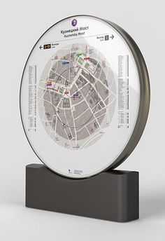 a glass plate with a map on it sitting on top of a black stand in front of a white wall