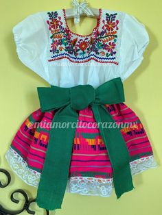 "Hot pink serape mexican dress, multicolor floral embroidery top, mexican party theme outfit, dia de la virgen dress, fiesta san antonio, cinco de mayo, hispanic heritage month, charro days, sombrero fest, mexidan dress, serape skirt, mexican blouse This adorable mexican dress - 3 pieces clothing set: Floral embroidered top, serape skirt and sash Skirt is black with a colorful design. Fit size 4-5 years old Measurements taken flat: Top Armpit to armpit 16\" Bottom hem width 17 1/4\" Shoulder to Multicolor Folk Dress For Fiesta, Multicolor Folk Style Dress For Fiesta, Folk Style Multicolor Dress For Fiesta, Multicolor Dress For Cinco De Mayo Fiesta, Multicolor Cotton Dress For Cinco De Mayo, Fitted Multicolor Dress For Cinco De Mayo, Multicolor Cotton Dress For Fiesta, Cotton Dress For Cinco De Mayo Fiesta, Cotton Dresses For Cinco De Mayo Fiesta