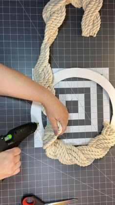 someone is making a rope wreath with scissors