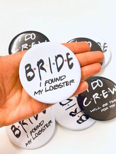 a hand holding some buttons that say bride found my lobster