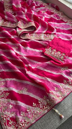 This beautiful Leheriya saree, crafted from 100% pure soft tussar silk, showcases the timeless charm of traditional design. Adorned with intricate Gota Patti work along with zardozi, sequins, and pearl embellishments, it is a masterpiece of craftsmanship. Perfect for festive and celebratory occasions, this saree brings elegance and sophistication to your ethnic wardrobe. Fabric of Saree: 100% Pure Soft Tussar Silk Leheriya Work: Gota Patti, Zardozi, Sequins & Pearl Care: Dry Clean Only *Product Festival Banarasi Silk Pre-draped Saree With Gota Work, Multicolor Georgette Pre-draped Saree With Gota Work, Navratri Silk Saree With Gota Work, Festival Banarasi Silk Pre-draped Saree With Dori Work, Chanderi Saree With Gota Work, Pink Chinon Salwar Kameez For Traditional Ceremonies, Semi-stitched Silk Saree With Gota Work, Navratri Gota Work Georgette Saree, Festival Dola Silk Saree With Gota Work