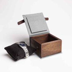 "A simple wooden watch box. The perfect gift for a watch lover. It is ideal for storing a watch that is not used every day. The box will also add a unique character to the watch that someone is about to give. Thanks to this box, the watch will be securely hidden. The box is made of solid mahogany. The bottom and lid of the box are covered with cotton fabric. Inside there is a satin black watch cushion. The box is closed with a natural leather strap. On the inside of the lid, there is room for a Minimalist Brown Watch As A Gift, Minimalist Brown Watch As Gift, Rectangular Watch Accessories In Original Box For Gift, Rectangular Watch Accessories With Original Box For Gifting, Rectangular Watches With Original Box As Gift, Rectangular Watch Accessories With Original Box For Gift, Modern Watch Accessories For Gifts, Personalised Wooden Box, Wooden Watch Box