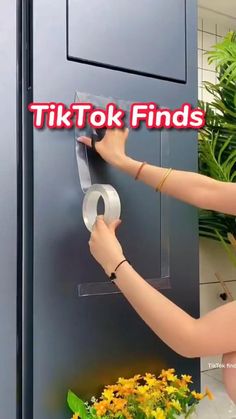 a woman is opening a door with a tape on it and the words tikt tok finds above her