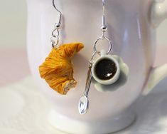 Croissant Earrings - Coffee & croissant Earrings - French Breakfast Jewelry - Breakfast Earrings - Food Jewelry - Coffee Earrings- Gift for Her cute bitten Croissant and coffee drink earrings, handmade out of resin and polymer clay. The cup is about 15 mm high. (0.5 inch) The earring hooks are nickel free. you will get the same as pictured. it could be a great gift for Mother's Day, Christmas, birthday, engagement, or any occasion including yourself. just keep away from little children because r Croissant And Coffee, Drink Earrings, Croissant Earrings, Earrings Coffee, Coffee Earrings, Crazy Earrings, Resin And Polymer Clay, Earrings Food, French Breakfast