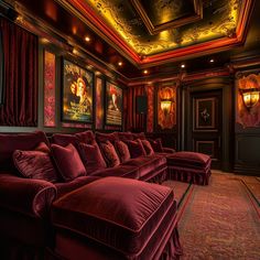 a theater with red velvet couches and movie posters