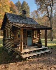 a small log cabin in the woods with steps leading up to it's front door