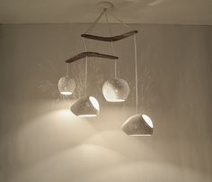 three lights hanging from the ceiling in a room