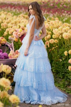 Fall in love with the ethereal beauty of the Sherri Hill 56260 dress from the Spring 2024 collection. 💖✨ This captivating piece is a true masterpiece, designed to make you feel like a princess on your special day. With its romantic silhouette and delicate details, it effortlessly exudes grace and elegance. The intricate lace bodice and flowing chiffon skirt create a dreamy harmony, while the sweetheart neckline adds a touch of allure. Perfect for formal occasions, weddings, or any event where y Blue Sweet 16 Dress, Bow Straps, Dress Shops, Sherri Hill Prom, Elegant Ball Gowns, Lace Evening Gowns, Lace Corset Top, Princess Sleeves, Sherri Hill Prom Dresses