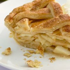 a piece of apple pie on a plate with ice cream and cinnamon sprinkles