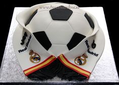 a cake shaped like a soccer ball on top of a white plate with black trim