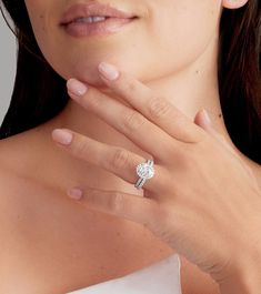 a close up of a person wearing a ring with a diamond on it's finger