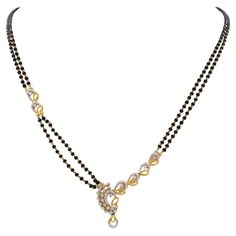 Graceful and timeless, this mangalsutra elegantly captures the essence of a sacred bond. A symphony of black beads and diamond embedded in gold. Made in Indian 22K Gold With Diamond Pendant and 2 strand Black beads chain Necklace approx. up to 18" in length Hook closure Total weight of 11.3 grams In great looking condition Wear consistent with time and use see images, please No original box or papers Black Beads Collection Gold, Elegant Black Beads With Gold Details, Long Black Beeds Chain Indian Gold, Blackbeeds Chain Long Gold, Long Blackbeads Gold, Black Beads Mangalsutra, Beads Chain, 22k Gold, Black Beads