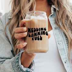 a woman is holding a glass with some liquid in it that says wedding planning fuel