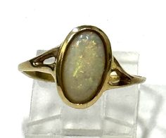 Ladies' vintage 14kt yellow gold ring with oval shape Australian opal center gem 12x6mm  *14k yellow gold *Total weight 2.5 grams *Size 7 (U.S.) can be resized with no charge Gold Oval Moonstone Ring For Formal Occasions, Oval Opal Ring In Yellow Gold Stamped 14k, Classic Oval Hallmarked Opal Ring, Heirloom Oval Opal Ring For Formal Occasions, Heirloom Oval Cabochon Opal Ring, Classic Oval Opal Ring Collectible, Collectible Gold Opal Ring With Gemstone, Oval Gold Opal Ring In 14k Gold, Vintage Yellow Gold Oval Moonstone Ring