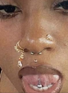 a woman with piercings on her nose and nose ring