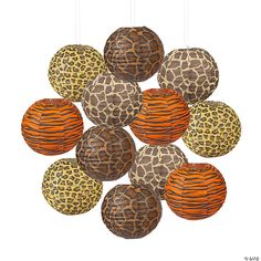 a bunch of animal print paper lanterns hanging from strings on a white background with orange and brown stripes