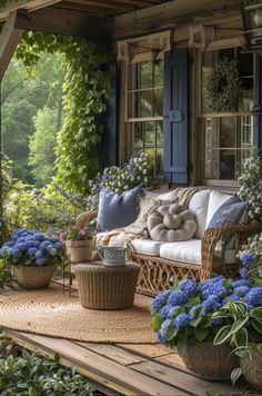 a porch with wicker furniture and blue flowers