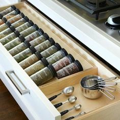 an open drawer holds spices and measuring spoons