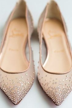 a pair of nude colored high heels with crystal embellishments