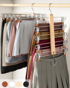 a rack with clothes hanging from it's hooks and two rows of skirts on hangers