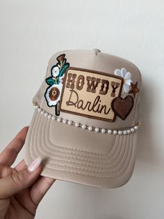 This custom made trucker patch hat is perfect for any occasion whether it be for spring/summer time, a lake hat, a gift for someone, or just a cute accessory to add a little spice to your outfit 🧢✨ DETAILS-  * This hat is one size with an adjustable SnapBack that is adjustable from 20in. - 23.5in. * The color of this hat is Tan * The material of the hat is polyester with iron on patches  REFUNDS AND CANCELLATIONS- Every hat is handmade by me as a result, a slight variation can occur from the picture with patch size or placement. If you have any problems with your hat please message me within 24 hours of receiving your order and I'd be happy to help! No refunds or exchanges will be accepted after. CONNECT- To enter giveaways, discount codes, or behind the scenes, follow our pages. 📲 Insta Cheap Trucker Hat With Letter Patch, Trendy Snapback Hat For Country Events, Country Style Baseball Cap For Spring, Snapback Hats For Country Events In Spring, Spring Western Trucker Hat, Spring Snapback Hats For Country Events, Trendy Trucker Hat For Spring Country Events, Western Style Snapback Hat For Spring, Western Snapback Trucker Hat For Spring