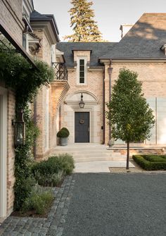 a large brick house with an entry way leading to the front door