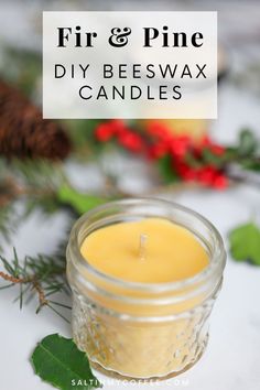 a candle sitting on top of a table next to pine cones and greenery with text overlay that reads fire & pine diy beeswax candles