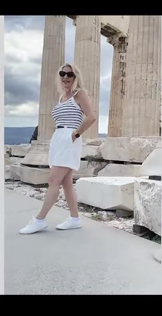 a woman standing in front of the parthenion with her hands on her hips