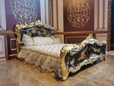 a gold and white bed sitting on top of a marble floor next to a wall