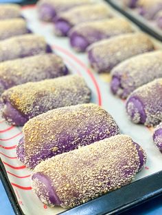 purple donuts are lined up on a baking sheet and ready to go into the oven