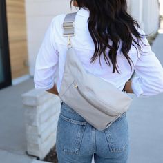 Enjoy the luxury of going hands-free with our Grey Fanny Pack. Designed to be ultra comfortable, this belt bag includes an air cushioned back panel and extra wide strap. Fun details include a key clip, and a rear water resistant phone pocket. Our Grey is light, crisp and elegant. The natural tones give you the ultimate style flexibility! Pairs great with your favorite jeans and tee. Fabric Stains, Waterproof Phone, Travel Budget, Key Clip, Pink Feathers, Air Pods, Slim Wallet, Crossbody Tote, Love Is Free