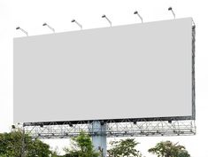 an empty billboard is shown in front of trees