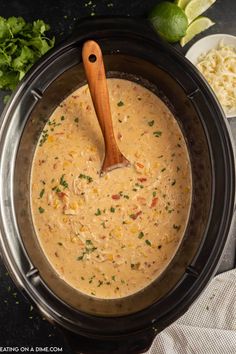 a crock pot filled with soup and garnished with cilantro