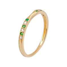 a gold ring with green and white stones