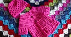 a crocheted baby's outfit and booties on a blanket