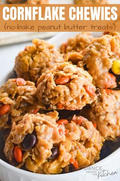 a white bowl filled with cookies and candy cornflakes on top of a table