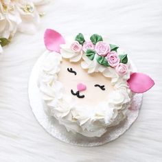 a cake decorated with white frosting and pink flowers