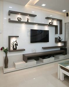 a modern living room with white walls and shelves