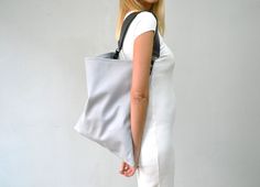 Akathi mat leather bag in light gray. A beautiful large hobo bag which is ideal for every day use. Not just a shoulder bag, a statetment tote which can easily be used as a shopper bag, even as a beach bag. It's loose minimalistic look makes it modern and unique.  Handmade in our studio from lux italian light gray cow leather and a premium cow leather for the strap in black. Big rectangular metal loops in gold or silver are used to connect the strap with the bag and a metal swivel clasp is added Gray Bags With Leather Handles For Shopping, Gray Tote Bucket Bag For Daily Use, Gray Tote Hobo Bag For Shopping, Gray Hobo Shoulder Bag For Shopping, Gray Hobo Bag With Removable Pouch For Everyday, Gray Bags With Leather Handles, Modern Gray Shoulder Bag For Everyday Use, Gray Travel Hobo Bag Tote, Everyday Gray Hobo Bag With Removable Pouch