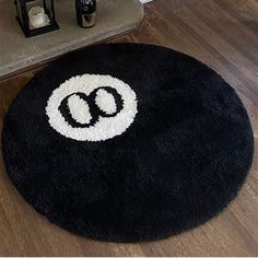 a black and white rug with the letter o on it in front of a door