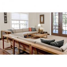 a living room filled with furniture and lots of windows