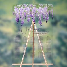 a wooden easel with purple flowers hanging from it