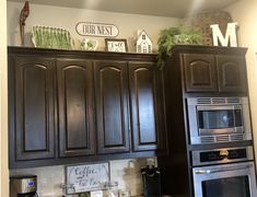 a kitchen with dark wood cabinets and stainless steel appliances