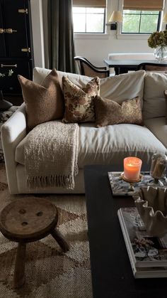 a living room filled with furniture and pillows