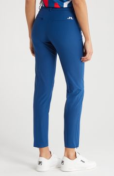 Stay comfortable while perfecting your swing in sleek cropped golf pants cut from the brand's Micro High Stretch™ fabric that offers plenty of stretch. 26 3/4" inseam; 10" leg opening; 9 3/4" front rise; 11 1/2" back rise (size 29) Zip fly with button closure Side zip pockets; back welt pockets Zip hems 48% recycled polyester, 38% polyester, 14% elastane Machine wash, tumble dry Imported Athleisure Stretch Bottoms For Golf, Stretch Athleisure Bottoms For Golf, Fitted Athleisure Bottoms For Golf, Fitted Tapered Leg Golf Pants, Straight Leg 4-way Stretch Bottoms For Golf, Sporty Moisture-wicking Blue Pants, 4-way Stretch Tapered Leg Golf Pants, Sports Pants With Micro-elastic Fit And 5-inch Inseam, Blue Straight Leg Pants With 4-way Stretch