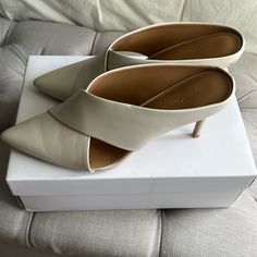 New In Box. Calvin Klein Leather Heeled Mules. Size 9. White Open Toe Mules For Work, White Wrapped Heel Heels For Work, Calvin Klein Heels For Office, White High Heel Mules For Work, Chic Slip-on Court Shoes For Spring, Cream Slip-on Heels For Work, Chic White Office Mules, Chic Cream Closed Toe Mules, Cream Heels With Wrapped Heel For Work