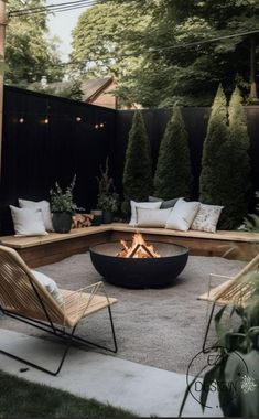 an outdoor fire pit surrounded by chairs and trees